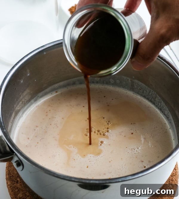 Ingredients for pumpkin spice latte laid out on a kitchen counter: milk, pumpkin puree, sugar, pumpkin pie spice, and coffee.