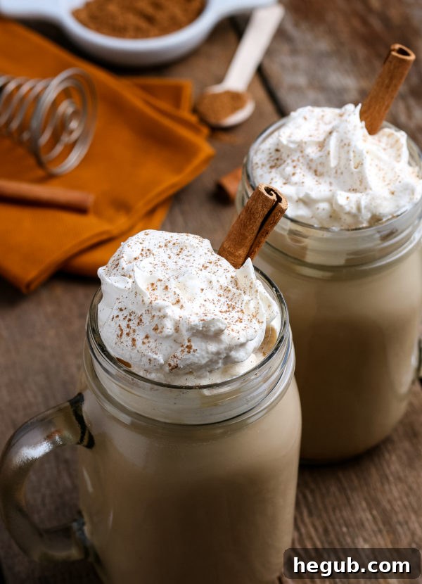 A close-up of a homemade pumpkin spice latte, highlighting the vibrant color and a cozy, inviting atmosphere.