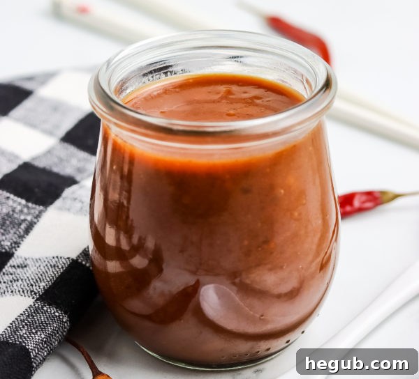 A bottle of gluten-free soy sauce next to a bowl of hoisin sauce ingredients, emphasizing a gluten-free lifestyle.