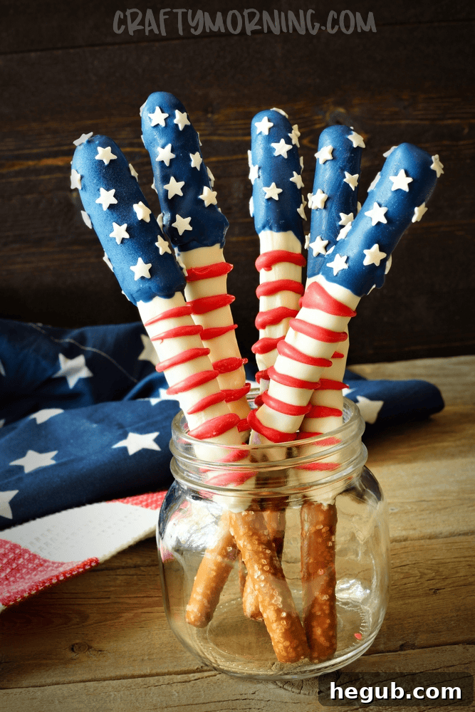 American Flag Pretzel Rods decorated with white chocolate and red and blue sprinkles