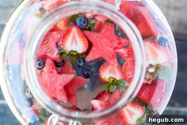 Star Spangled Fruit Infused Water in a pitcher with berries