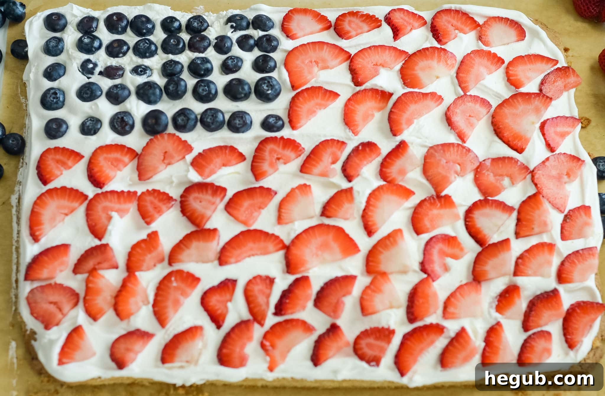 American Flag Cookie Cake decorated with fresh strawberries and blueberries