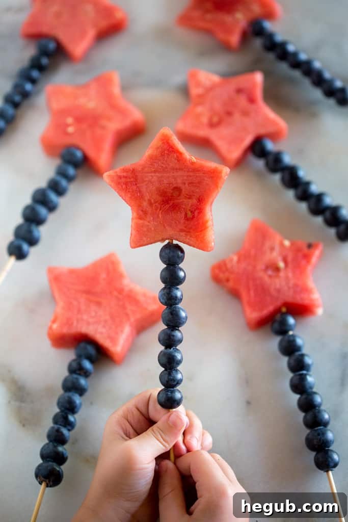 Healthy and colorful Fruit Sparklers on wooden sticks