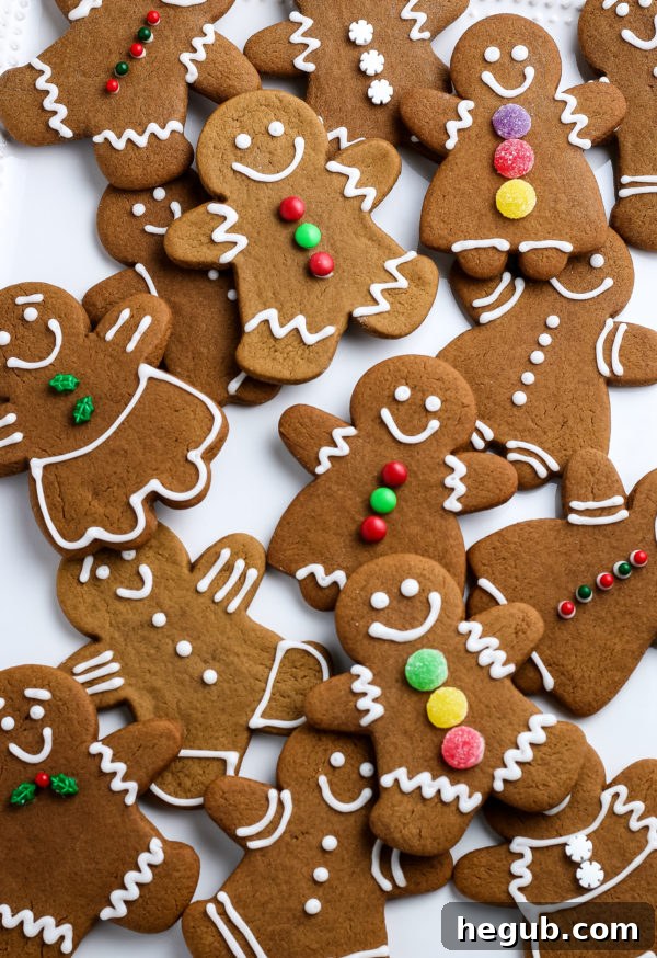 Freshly baked gingerbread cookies decorated with white icing, arranged artfully on a cooling rack.