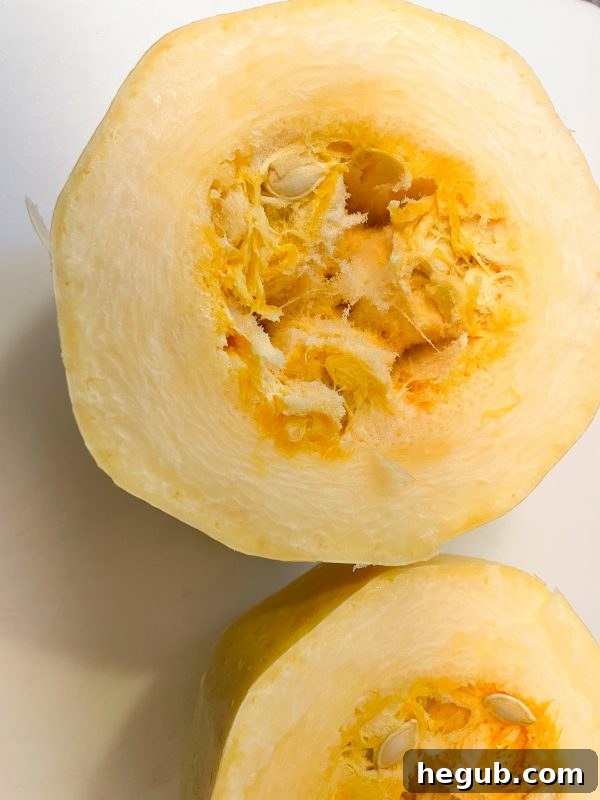 scooping seeds from spaghetti squash
