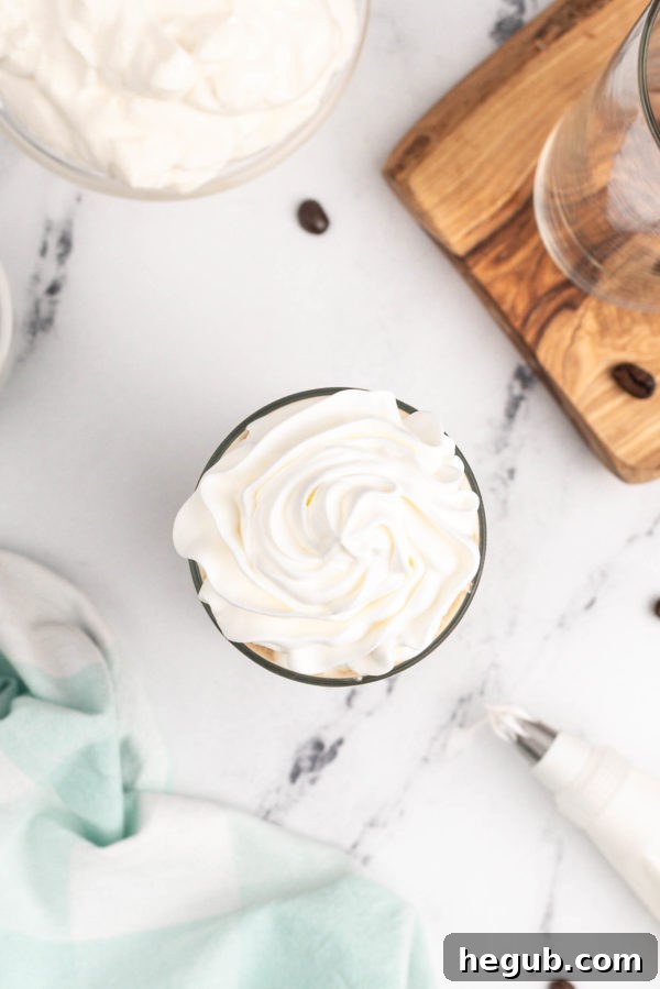 Preparing homemade whipped cream with a stand mixer for frozen mocha coffee.