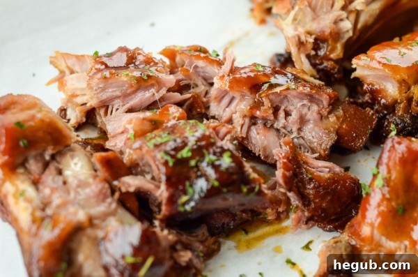 This image shows the tender meat of slow cooker baby back ribs.