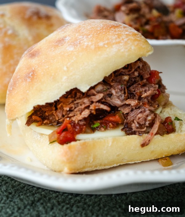 Effortless Slow Cooker Italian Roast 6 slow cooker italian roast recipe on bun with provolone