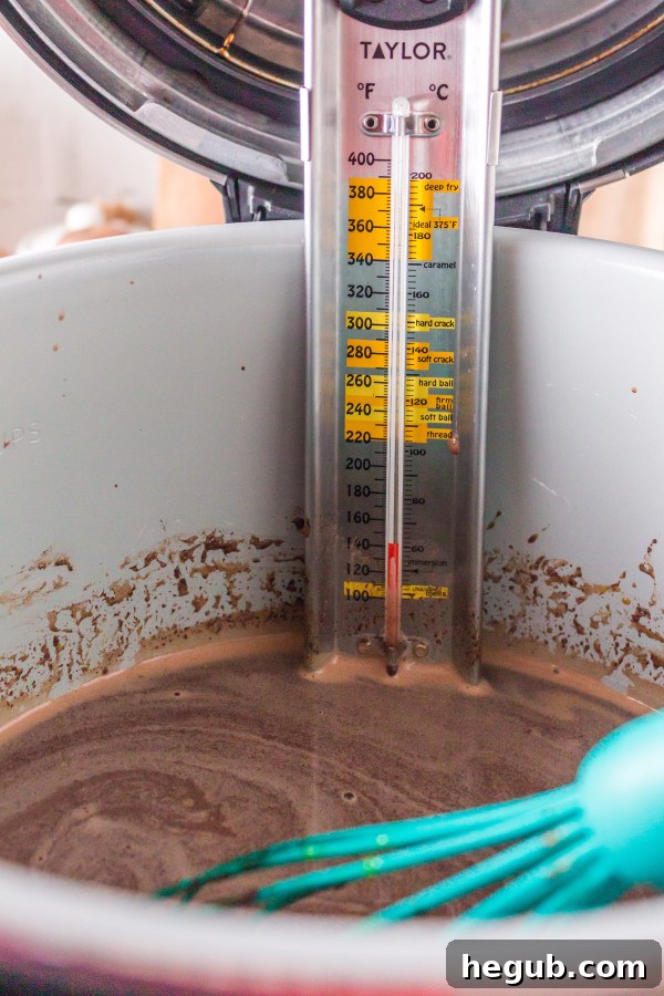 Pressure cooker inner pot with chocolate pudding ingredients being whisked.